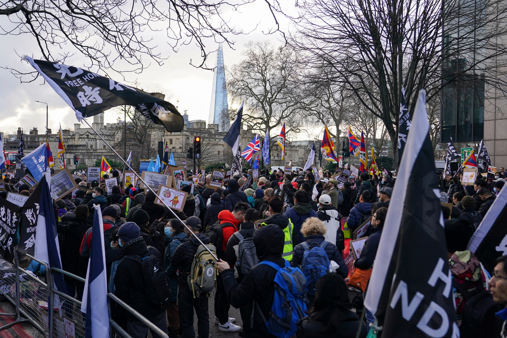 Demonstrators hold placards and flags as they attend a protest against the opening of the new Chinese embassy, in London, Saturday, Jan. 17, 2026. (AP Photo/Alberto Pezzali)