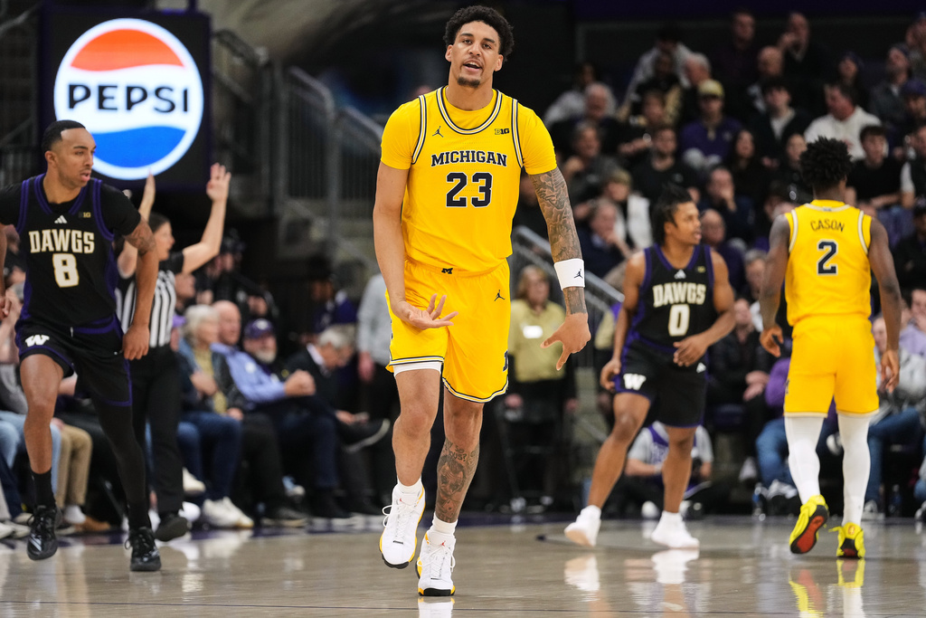 Michigan forward Yaxel Lendeborg reacts after a basket against Washington during the first half of an NCAA college basketball game Wednesday, Jan. 14, 2026, in Seattle. (AP Photo/Lindsey Wasson)