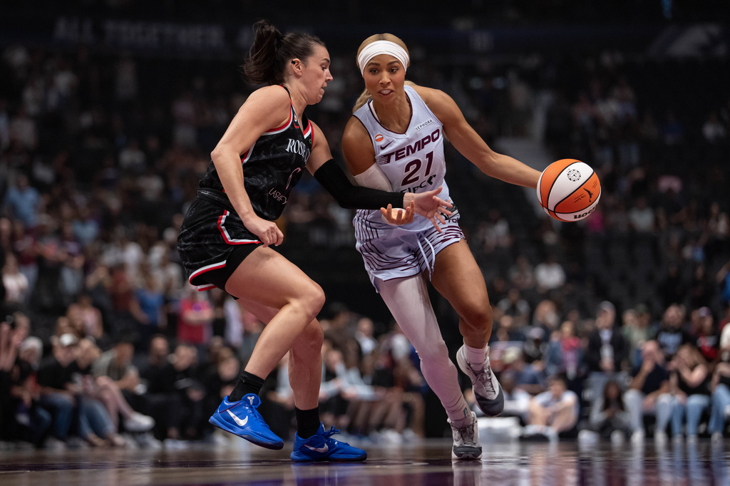 Portland Fire's Bridget Carleton (6) defends against Toronto Tempo's Isabelle Harrison (21) during the first half of a WNBA basketball game in Vancouver, British Columbia, Friday, Aug. 21, 2026. (Ethan Cairns/The Canadian Press via AP)
