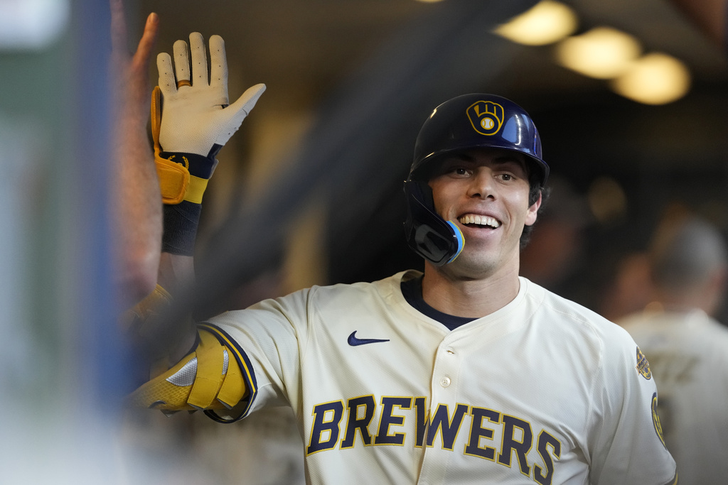 Milwaukee Brewers' Christian Yelich smiles in the dugout after hitting a solo home run during the third inning of a baseball game against the Pittsburgh Pirates, Monday, Aug. 11, 2025, in Milwaukee. (AP Photo/Aaron Gash)
