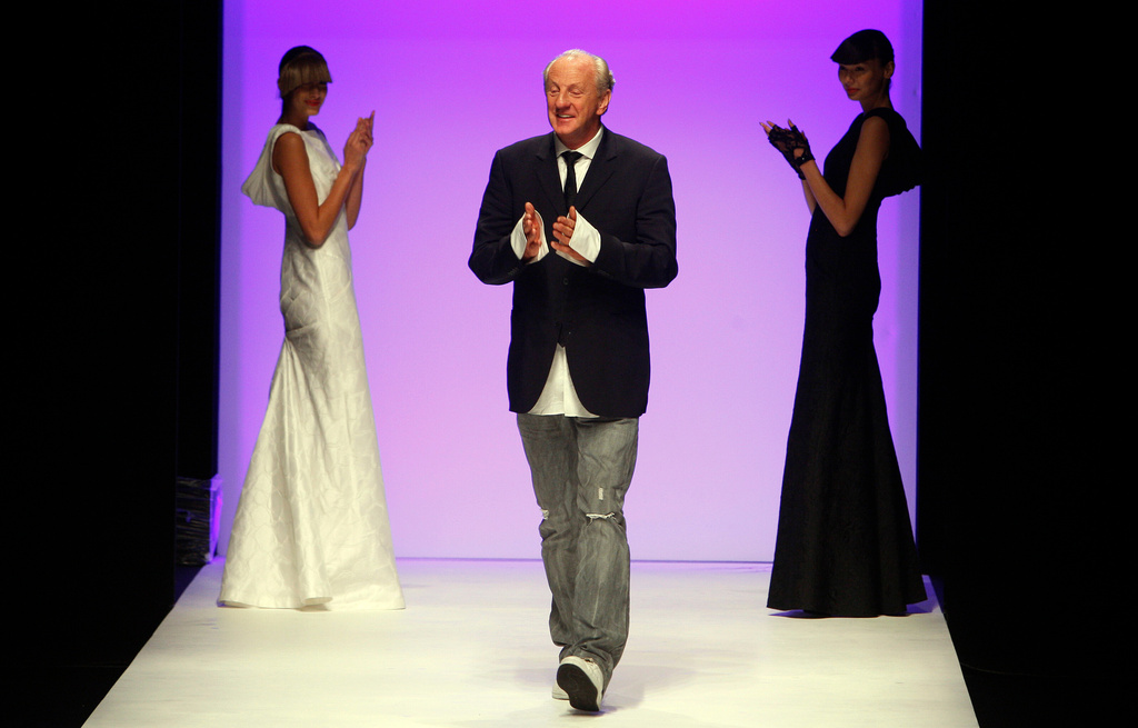 FILE - Irish designer Paul Costelloe is applauded by models after his show during London Fashion Week, in London, Friday, Sept. 18, 2009. (AP Photo/Kirsty Wigglesworth, File)