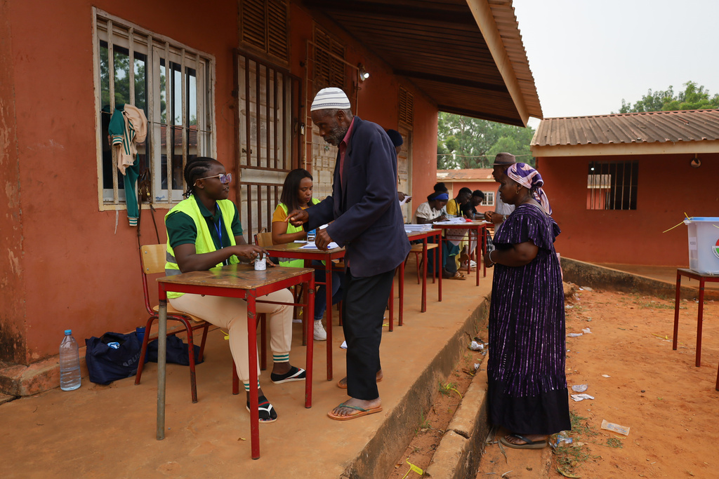 People prepare to cast their ballots during the presidential and legislative elections, in Bissau, Guinea-Bissau, Sunday, Nov. 23, 2025. (AP Photo/Darcicio Barbosa)