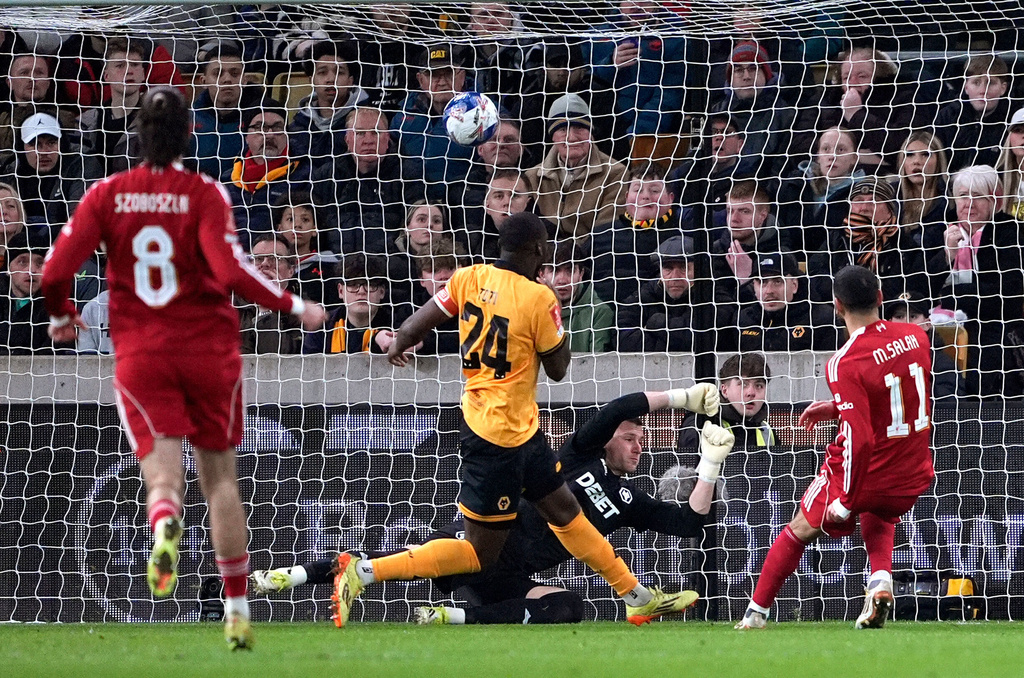 Liverpool's Mohamed Salah, right, scores their second goal of the game during an English FA Cup fifth round match against Wolverhampton Wanderers, Friday, March 6, 2026, in Wolverhampton, England. (Peter Byrne/PA via AP)