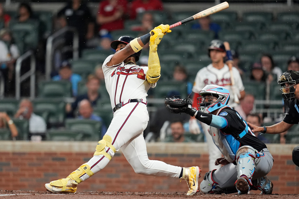 Atlanta Braves' Ronald Acuña Jr. (13) hits a two-run homer against the Miami Marlins in the third inning of a baseball game, Thursday, Aug. 6, 2026, in Atlanta. (AP Photo/Mike Stewart)