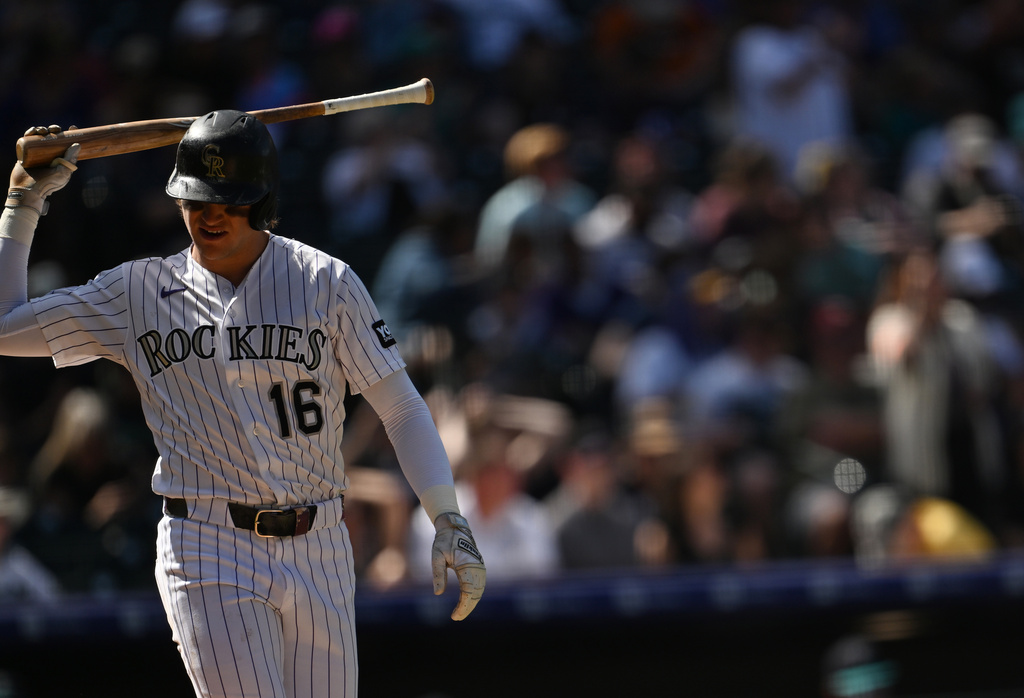 Colorado Rockies center fielder Cole Carrigg tosses his bat after striking out in the fourth inning against the Seattle Mariners during a baseball game Sunday, Sept. 20, 2026, in Denver. (AP Photo/RJ Sangosti)