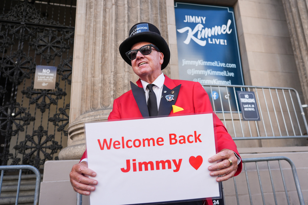 Gregg Donovan holds a sign that says "Welcome Back Jimmy" in front of the Jimmy Kimmel Live studio on Hollywood Blvd., on Tuesday, Sept. 23, 2025, in Los Angeles. (AP Photo/Chris Pizzello)