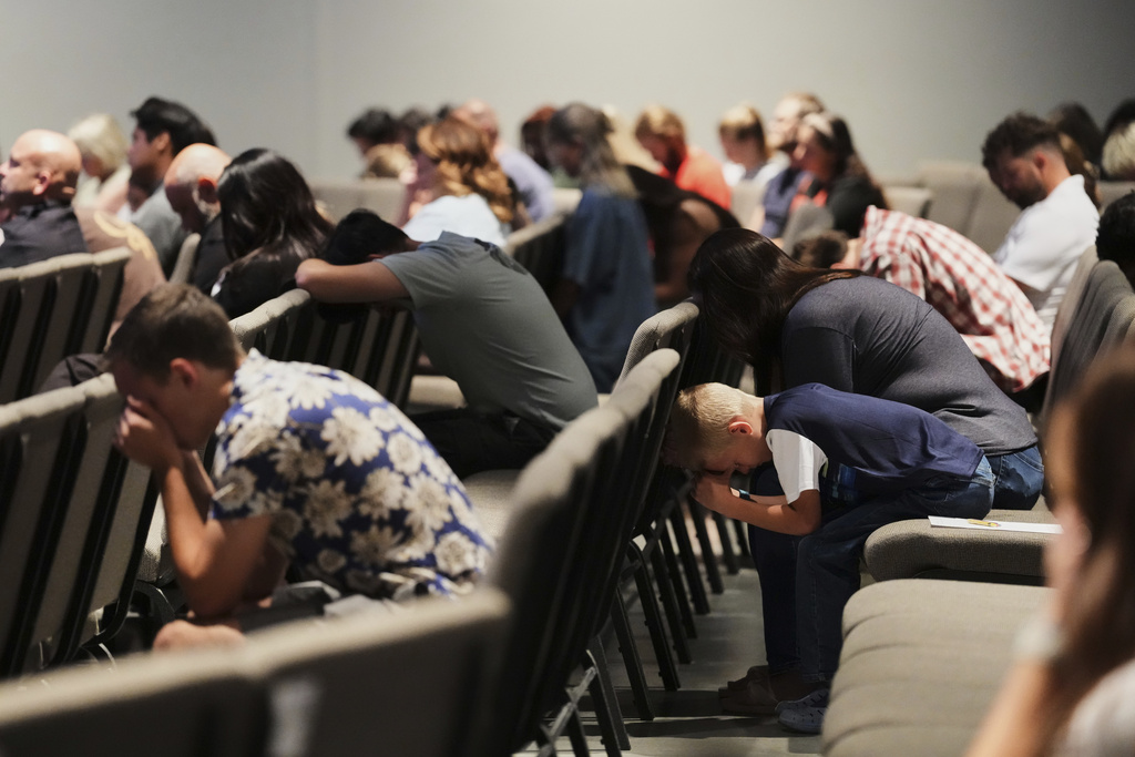 Congregants bow their heads during a prayer event at CenterPoint Church the day after Charlie Kirk, the CEO and co-founder of Turning Point USA was shot and killed, Thursday, Sept. 11, 2025, in Orem, Utah. (AP Photo/Lindsey Wasson)