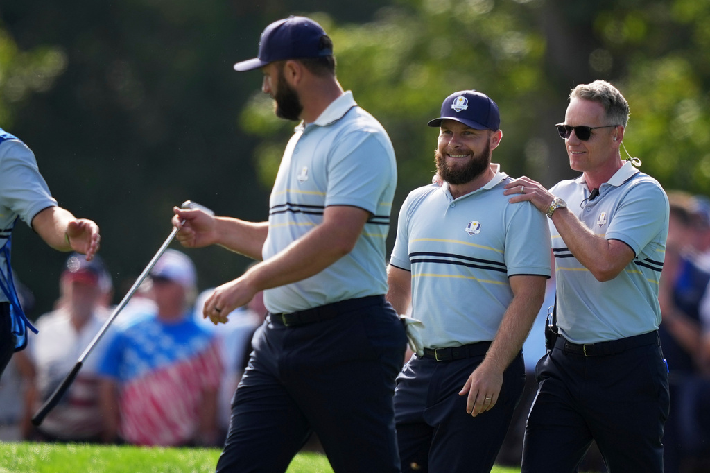 Europe's Jon Rahm, Tyrrell Hatton and captain Luke Donald walk down on the 11th hole at Bethpage Black golf course during the Ryder Cup golf tournament, Friday, Sept. 26, 2025, in Farmingdale, N.Y. (AP Photo/Matt Slocum)