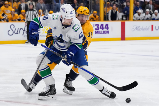 Vancouver Canucks center Elias Pettersson (40) passes the puck past Nashville Predators left wing Cole Smith (36) during the first period of an NHL hockey game Thursday, Oct. 23, 2025, in Nashville, Tenn. (AP Photo/George Walker IV) Vancouver Canucks center Elias Pettersson (40) passes the puck past Nashville Predators left wing Cole Smith (36) during the first period of an NHL hockey game Thursday, Oct. 23, 2025, in Nashville, Tenn. (AP Photo/George Walker IV)