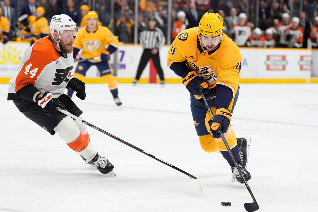 Nashville Predators defenseman Nicolas Hague (41) skates the puck past Philadelphia Flyers left wing Nicolas Deslauriers (44) during the second period of an NHL hockey game Thursday, Nov. 6, 2025, in Nashville, Tenn. (AP Photo/George Walker IV)
