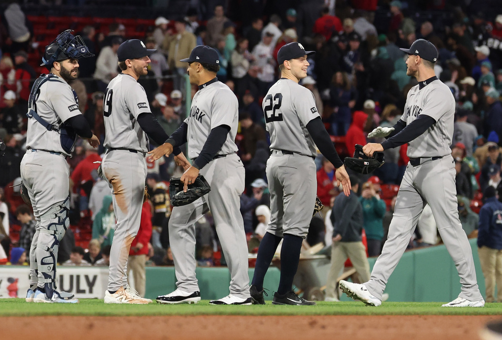 New York Yankess outfielders and infielders high-five after beating the Boston Red Sox in a baseball game Thursday, April 23, 2026, in Boston. (AP Photo/Mark Stockwell)