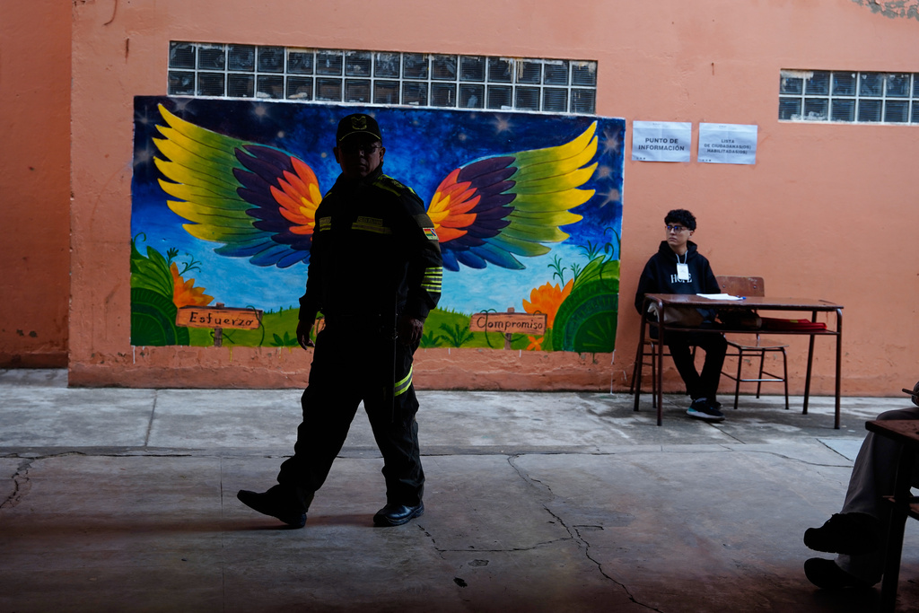 A police officer guards a polling station during a presidential runoff election in Tarija, Bolivia, Sunday, Oct. 19, 2025. (AP Photo/Freddy Barragan)