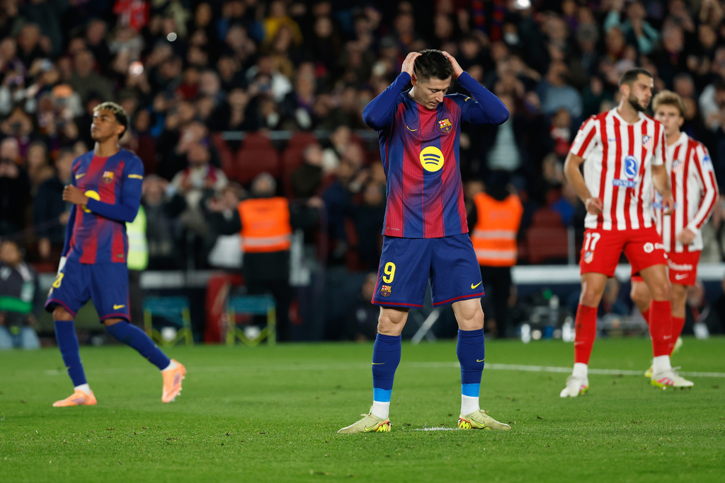 Barcelona's Robert Lewandowski reacts after missing a penalty kick, during a Spanish La Liga soccer match between Barcelona and Atletico de Madrid, in Barcelona, Spain, Tuesday, Dec.2, 2025. (AP Photo/Joan Monfort)