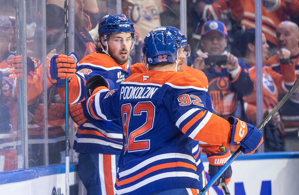 Edmonton Oilers' Noah Philp (48) and Vasily Podkolzin (92) celebrate a goal against the Vancouver Canucks during the second period of an NHL hockey game in Edmonton, Alberta, Saturday, Oct. 11, 2025. (Jason Franson/The Canadian Press via AP)