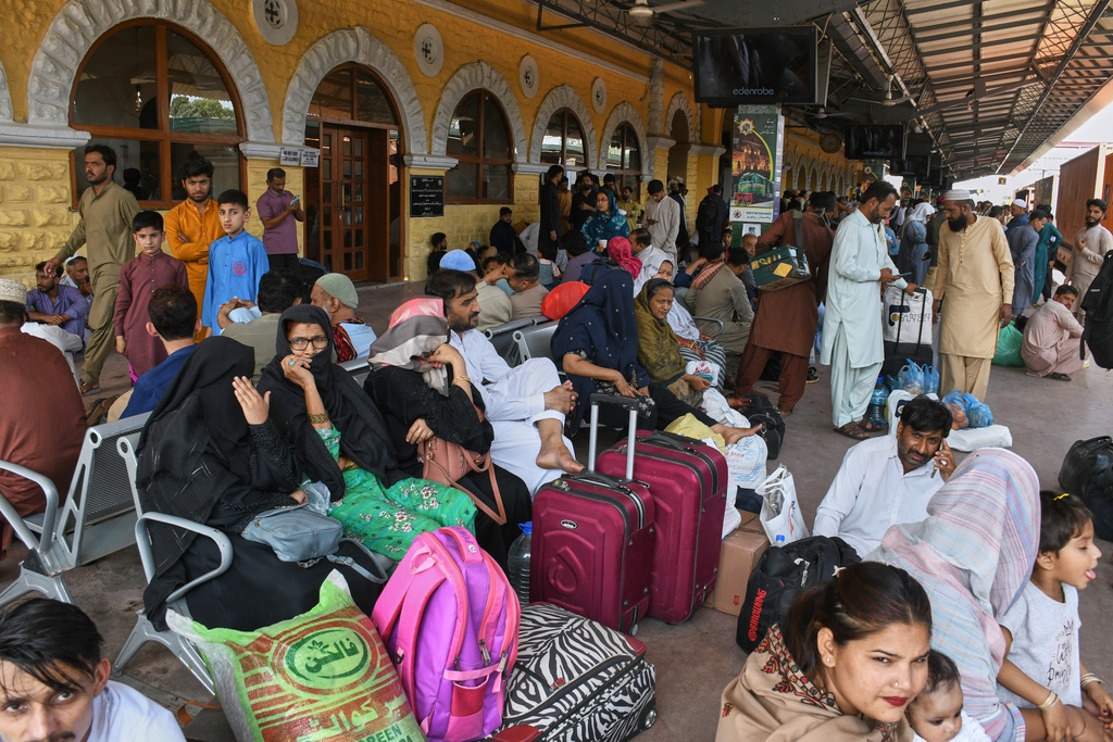 People wait to board passenger train to return home to celebrate the upcoming Eid al-Fitr holidays, marking the end of the Islamic holy fasting month of Ramadan, at a railway station in Karachi, Pakistan, Tuesday, March 17, 2026. (AP Photo/Ali Raza)
