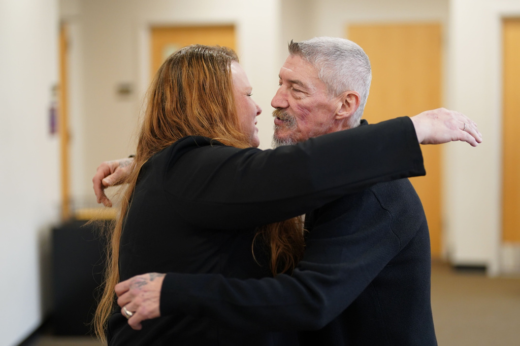 James Pugh, who served more than 30 years in prison for charges in the 1993 homicide of Deborah Meindl before his conviction was overturned, hugs Lisa Meindl Payne, the victim's daughter after the case against Pugh in a potential retrial was dismissed on Tuesday, Dec. 2, 2025 in Buffalo, N.Y. (Derek Gee/The Buffalo News via AP)