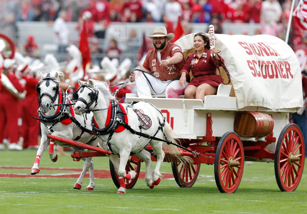 Members of the Oklahoma Spirt groups Ruf Neks and Lil Sis drive the Oklahoma Sooner Schooner across the field during pregame of an NCAA college football game between Missouri and Oklahoma Saturday, Nov. 22, 2025, in Norman, Okla. (AP Photo/Alonzo Adams)