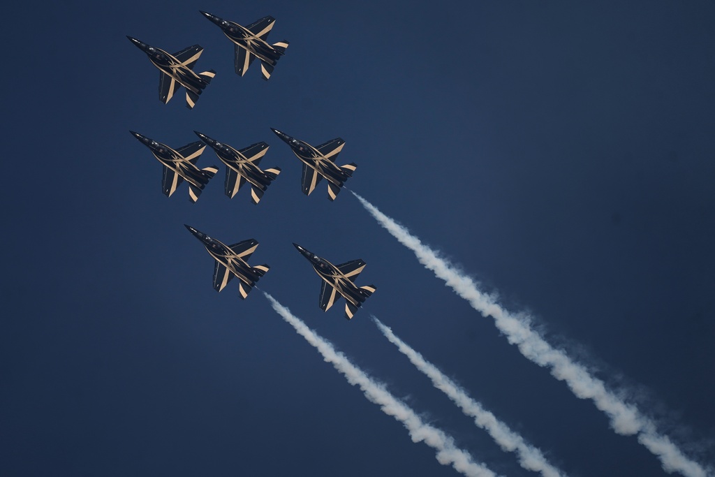 Fursan Al Emarat, the aerobatics demonstration team of the United Arab Emirates Air Force, performs during the Dubai Air Show in Dubai, United Arab Emirates, Tuesday, Nov. 18, 2025. (AP Photo/Fatima Shbair)