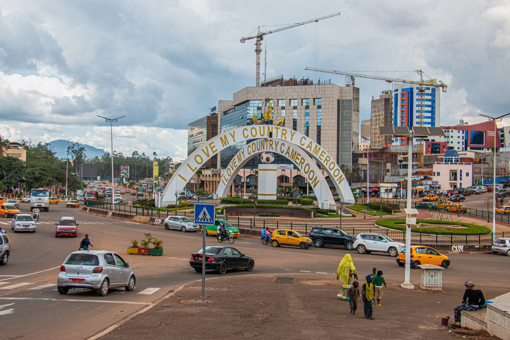 FILE - Cars drive through an intersection near a monument in Yaoundé, Cameroon, Sept. 12, 2025. (AP Photo / Welba Yamo Pascal, file)
