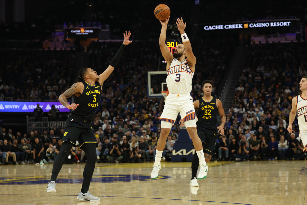 Phoenix Suns forward Dillon Brooks (3) shoots against Golden State Warriors guard Will Richard (3) during the first half of an NBA basketball game in San Francisco, Saturday, Dec. 20, 2025. (AP Photo/Jed Jacobsohn)