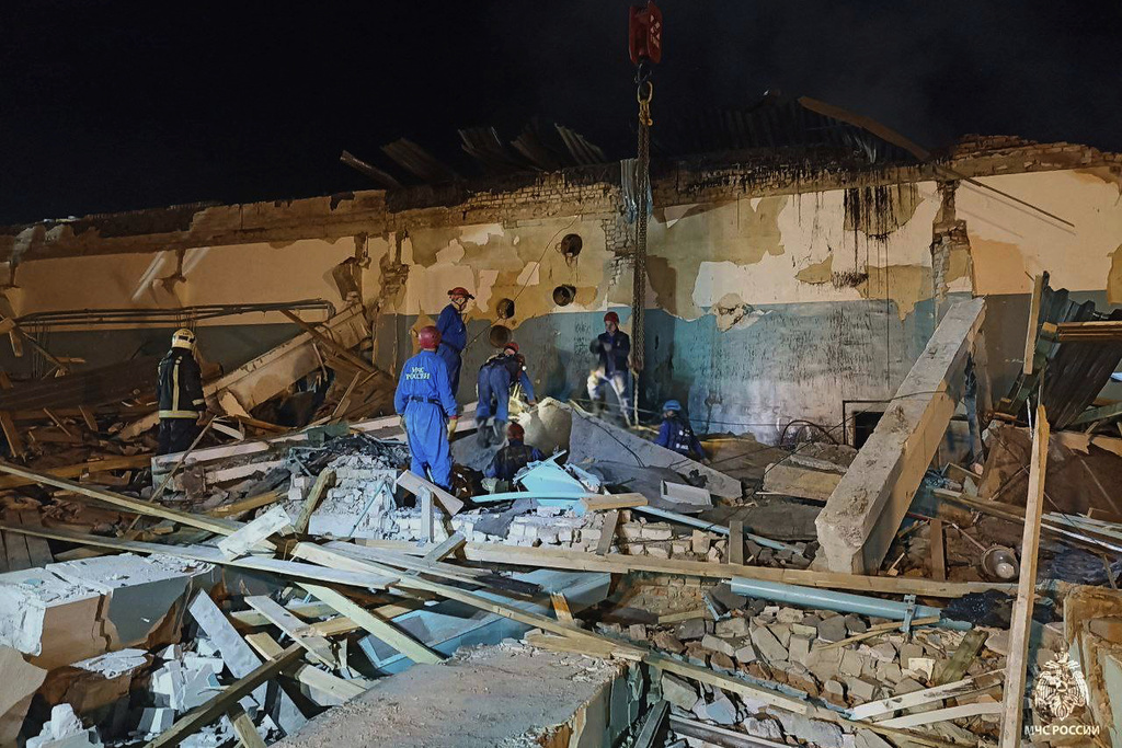 In this photo, released by the Russian Emergency Ministry Press Service on Saturday, Aug. 16, 2025, Emergency Ministry employees work in debris of an industrial plant after a fire at the facility in the Shilovsky District, Ryazan region, around 250 kilometers (155 miles) southeast of Moscow, Russia. (Russian Emergency Ministry Press Service via AP)