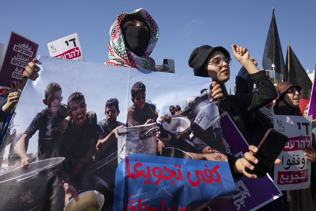 Israeli and Palestinian activists take part in a protest calling for the end of the war and an end to starvation in the Gaza Strip, as they gather in Tel Aviv, Israel, Saturday, Aug. 23, 2025. (AP Photo/Maya Levin)