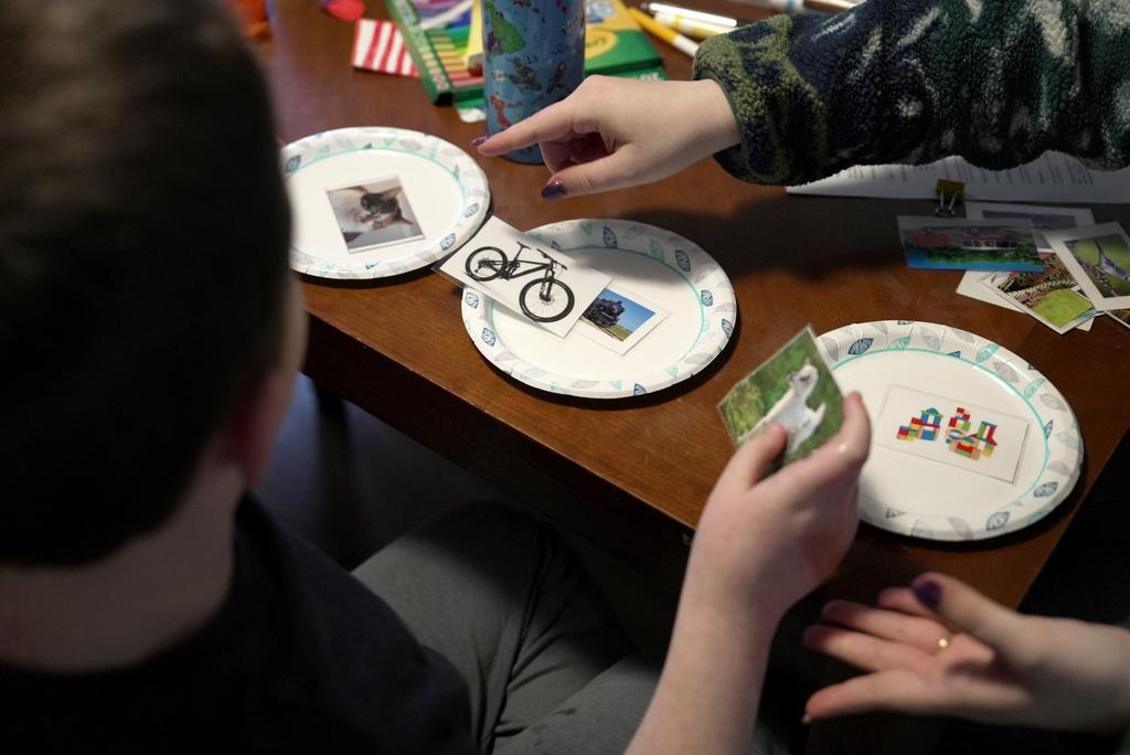 Ronan Murphy works on a sorting problem during an applied behavior analysis after school in his home in Ayer, Mass., on Friday, Jan. 16, 2026. (AP Photo/Shelby Lum)
