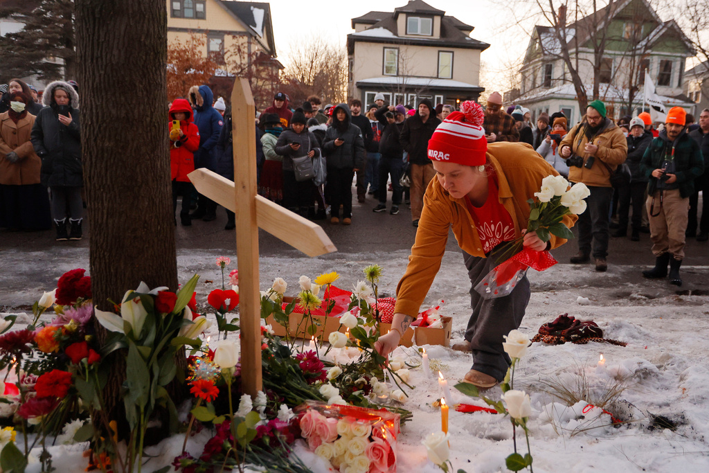 People gather for a vigil after an Immigration and Customs Enforcement officer shot and killed a motorist earlier in the day, Wednesday, Jan. 7, 2026, in Minneapolis. (AP Photo/Bruce Kluckhohn)