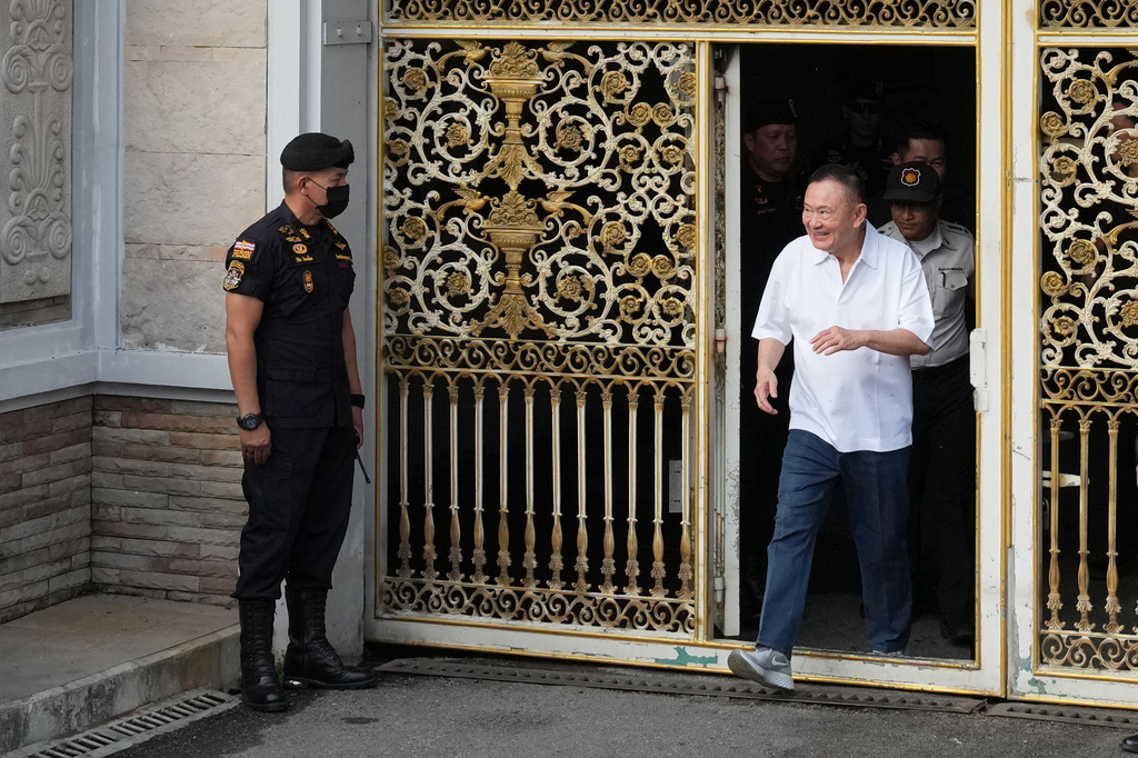 Former Thailand Prime Minister Thaksin Shinawatra walks out of a Bangkok prison as he gets released on parole in Bangkok, Thailand, Monday, May 11, 2026. (AP Photo/Sakchai Lalit)
