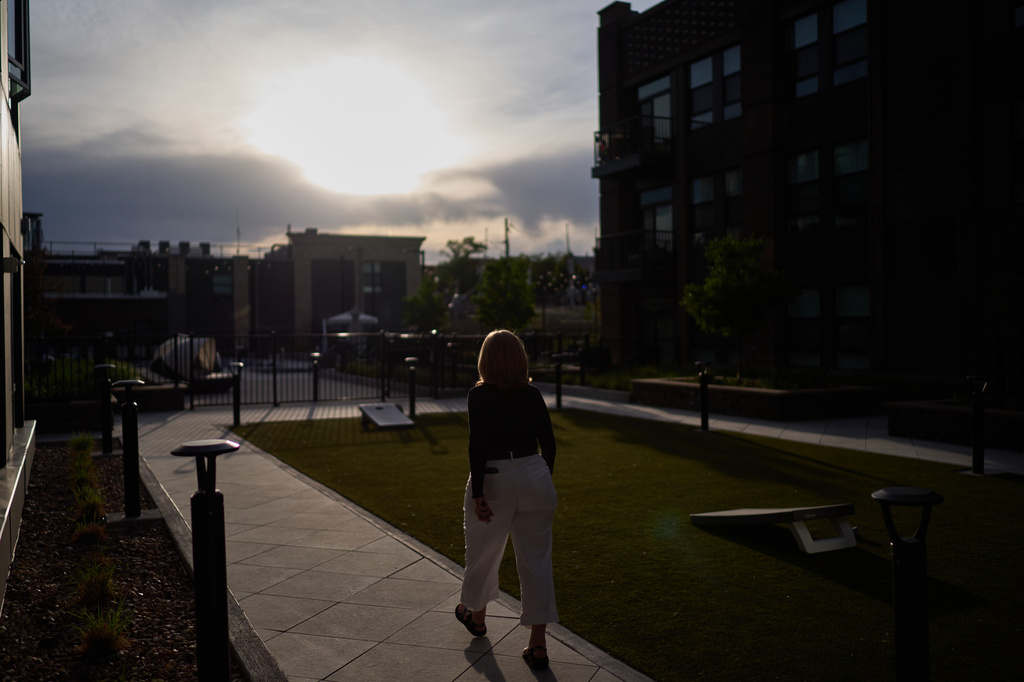 Debra Fox, who had $58,000 stolen from her in a romance scam, goes for a walk outside her apartment complex, Wednesday, May 13, 2026, in Arvada, Colo. (AP Photo/David Goldman)