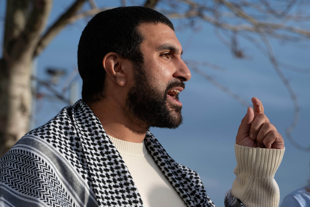 British political commentator Sami Hamdi speaks to the media in London, Thursday, Nov. 13, 2025, on his return to the U.K. after he was arrested by Immigration and Customs Enforcement on Oct. 26 while on a speaking tour in the U.S.. (AP Photo/Thomas Krych)