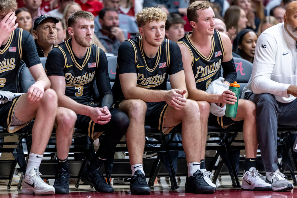Purdue guard Braden Smith (3) sits with guard Jack Benter, center, and guard Fletcher Loyer (2) during the first half of an NCAA college basketball game against Alabama, Thursday, Nov. 13, 2025, in Tuscaloosa, Ala. (AP Photo/Vasha Hunt)
