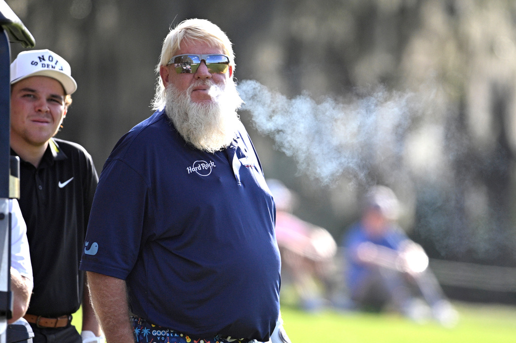 John Daly waits to hit from the 14th fairway as his son John Daly II looks on during the final round of the PNC Championship golf tournament, Sunday, Dec. 21, 2025, in Orlando, Fla. (AP Photo/Phelan M. Ebenhack)