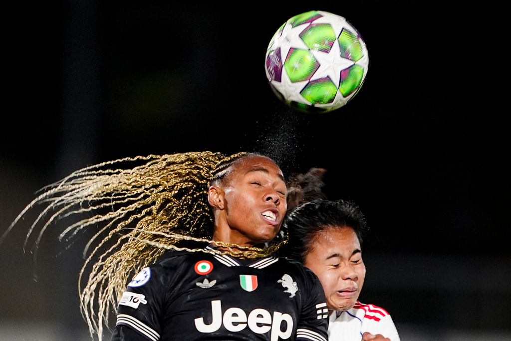 OL Lyonnes's Alice Sombath, right, jumps for the ball with Juventus' Lindsey Thomas during the women's Champions League soccer match between Juventus and OL Lyonnes in Biella, Italy, Wednesday, Nov. 19, 2025. (Fabio Ferrari/LaPresse via AP)