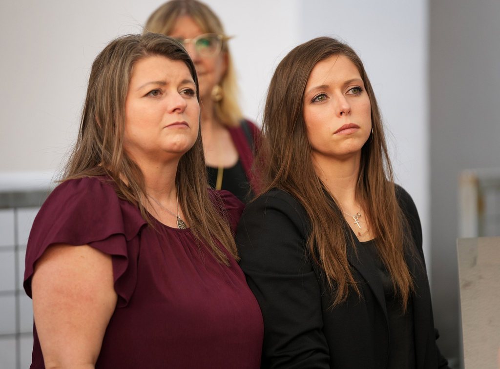 FILE - Kim Pierce, left, the widow of yogurt shop suspect, Maurice Pierce, and their daughter, Marisa, right, listen to a news conference on Feb. 19, 2026, after Maurice was exonerated for the 1991 Austin yogurt shop murders in Austin, Texas. (Jay Janner/Austin American-Statesman via AP, File)