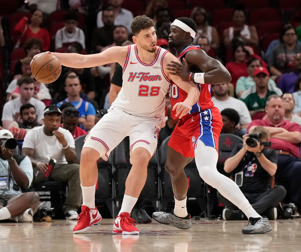 Houston Rockets center Alperen Sengun (28) controls the ball against Philadelphia 76ers center Adem Bona (30) during the first half of an NBA basketball game, Thursday, April 9, 2026, in Houston. (AP Photo/ Karen Warren)