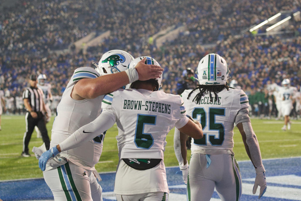 Tulane wide receiver Anthony Brown-Stephens (5) celebrates after his touchdown against Memphis with offensive lineman Jack Hollifield, left, and Jamauri McClure (25) during the first half of an NCAA college football game, Friday, Nov. 7, 2025, in Memphis, Tenn. (AP Photo/Nikki Boertman)