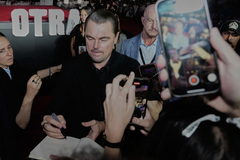 Leonardo DiCaprio greets fans during a red carpet event for the film "One Battle After Another" in Mexico City, Thursday, Sept. 18, 2025. (AP Photo/Marco Ugarte)