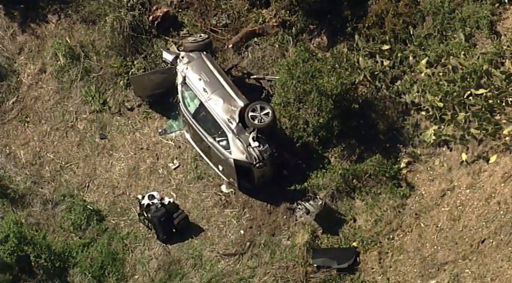FILE - In this aerial image take from video provided by KABC-TV, a vehicle rest on its side after a rollover accident involving golfer Tiger Woods along a road in the Rancho Palos Verdes suburb of Los Angeles, Tuesday, Feb. 23, 2021. (KABC-TV via AP, File)