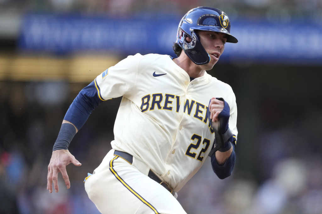 Milwaukee Brewers' Christian Yelich rounds third base on his way to scoring on a two-run RBI double hit by Blake Perkins during the first inning of a baseball game against the Philadelphia Phillies, Monday, Sept. 1, 2025, in Milwaukee. (AP Photo/Kayla Wolf)