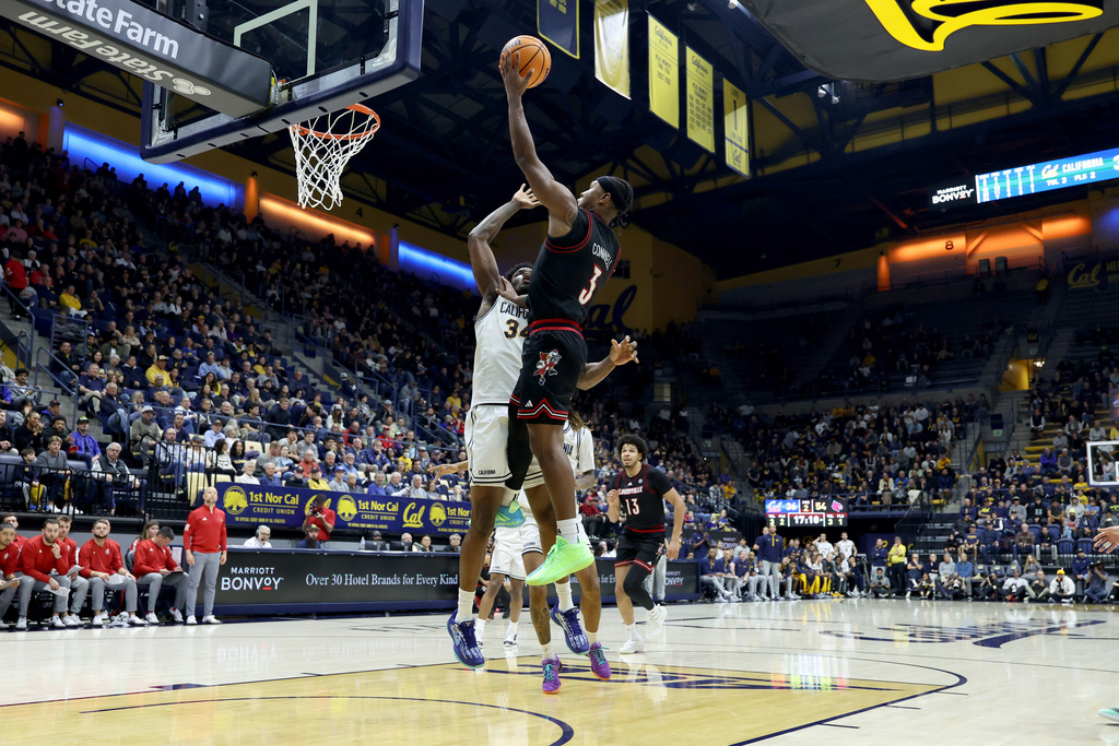 Louisville guard Ryan Conwell (3) shoots against California forward Lee Dort (34) during the second half of an NCAA college basketball game in Berkeley, Calif., Tuesday Dec. 30, 2025. (AP Photo/Jed Jacobsohn)