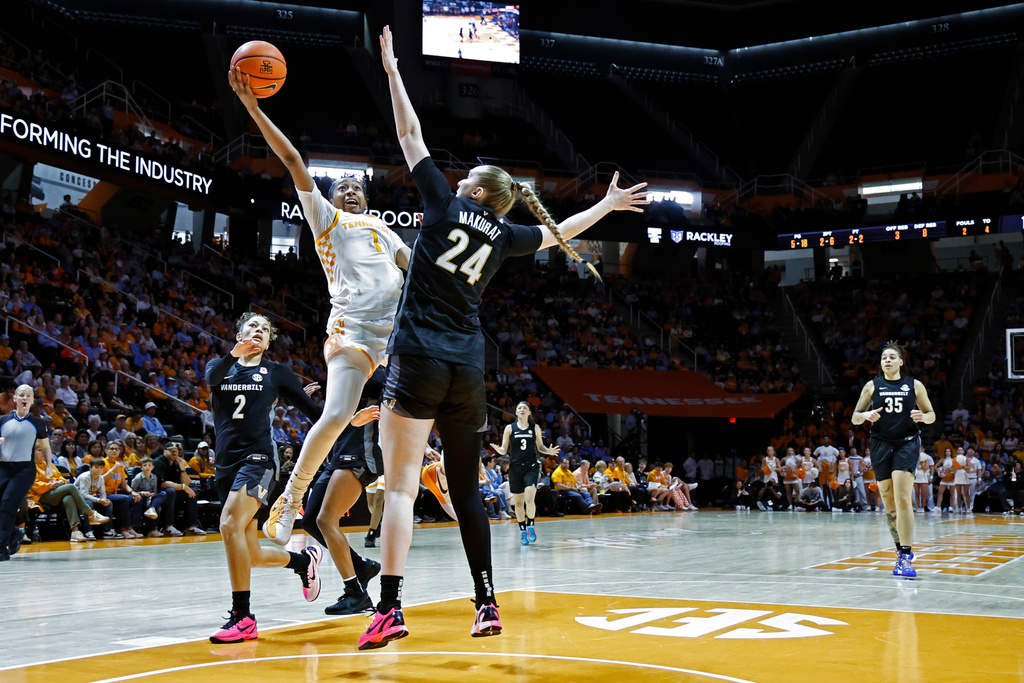 Tennessee guard Nya Robertson (1) goes up to shoot over Vanderbilt guard Aga Makurat (24) during the first half of an NCAA college basketball game in Knoxville, Tenn., Sunday, March 1, 2026. (AP Photo/Wade Payne)
