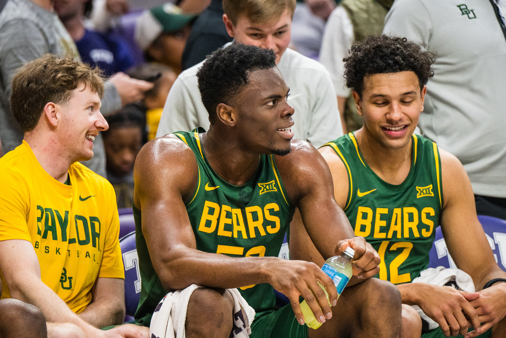 Baylor center James Nnaji laughs with team mates on the bench during an NCAA college basketball game against TCU, Saturday, Jan. 3, 2026, Fort Worth, Texas. (AP Photo/Jessica Tobias)