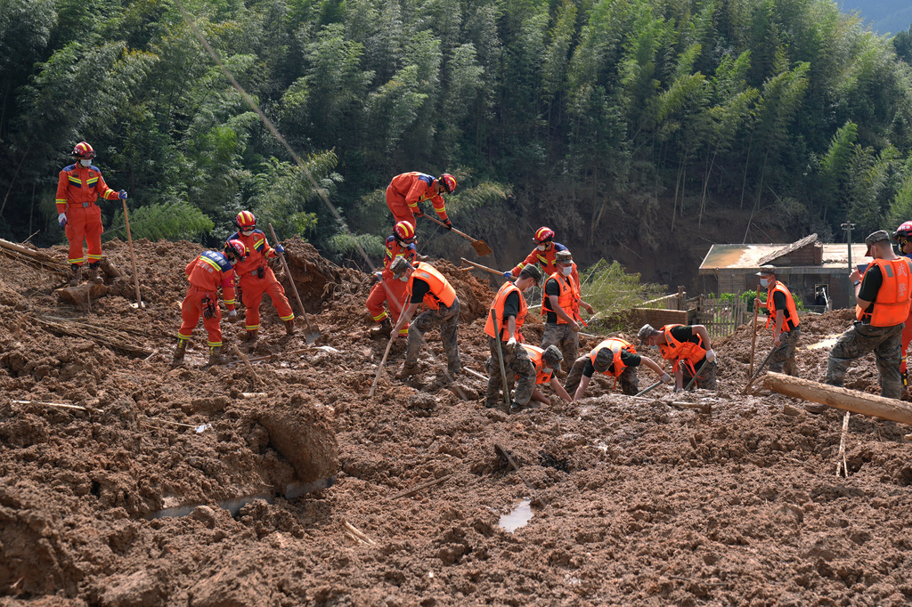 In this photo released by Xinhua News Agency, rescuers search for survivors in a mudslide-hit area of Mingkeng village in Suichuan, in China's eastern province of Jiangxi, Sunday, Sept. 6, 2026. (Wan Xiang/Xinhua via AP)