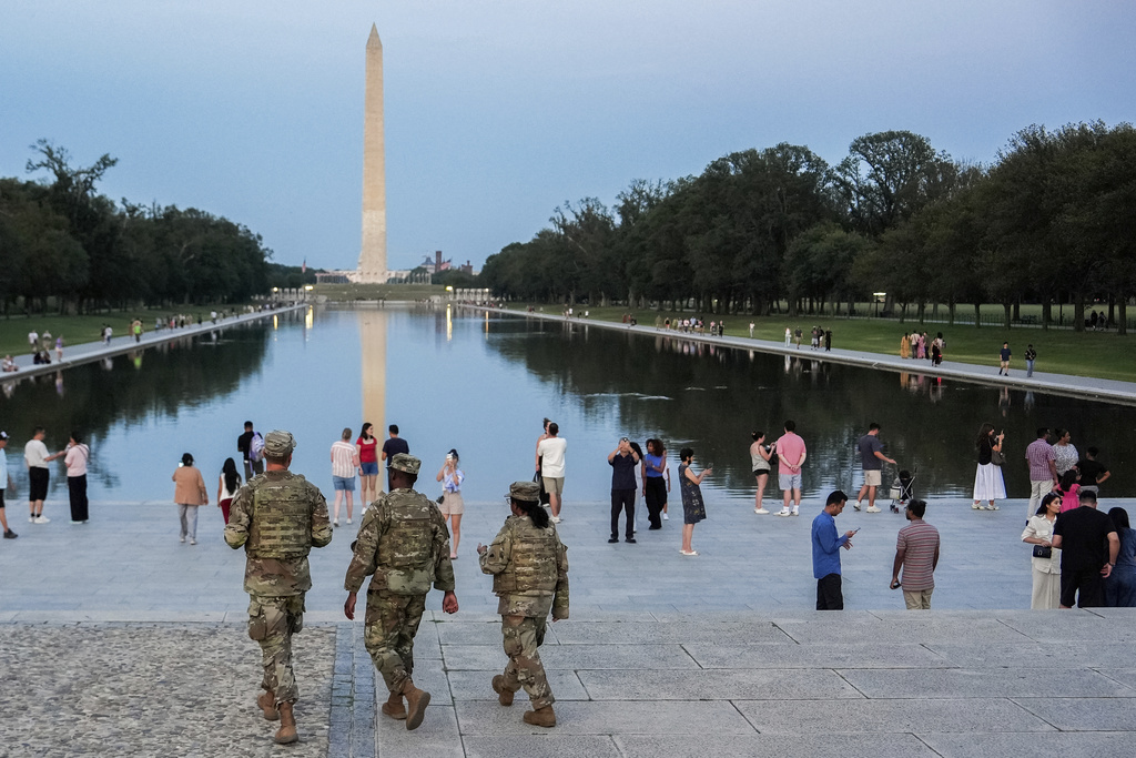 Members of the District of Columbia National Guard patrol along the National Mall, Saturday, Aug. 16, 2025, in Washington. (AP Photo/Julia Demaree Nikhinson)