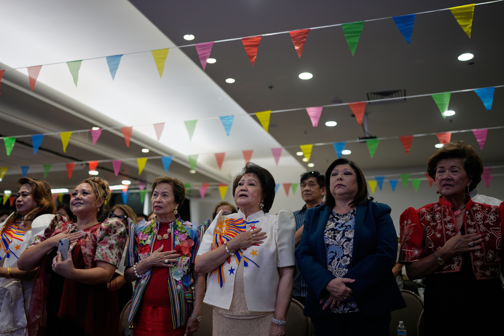People stand during the national anthem at an event for the designation of Filipino Town as a Clark County Cultural District, Thursday, Oct. 9, 2025, in Las Vegas. (AP Photo/John Locher)