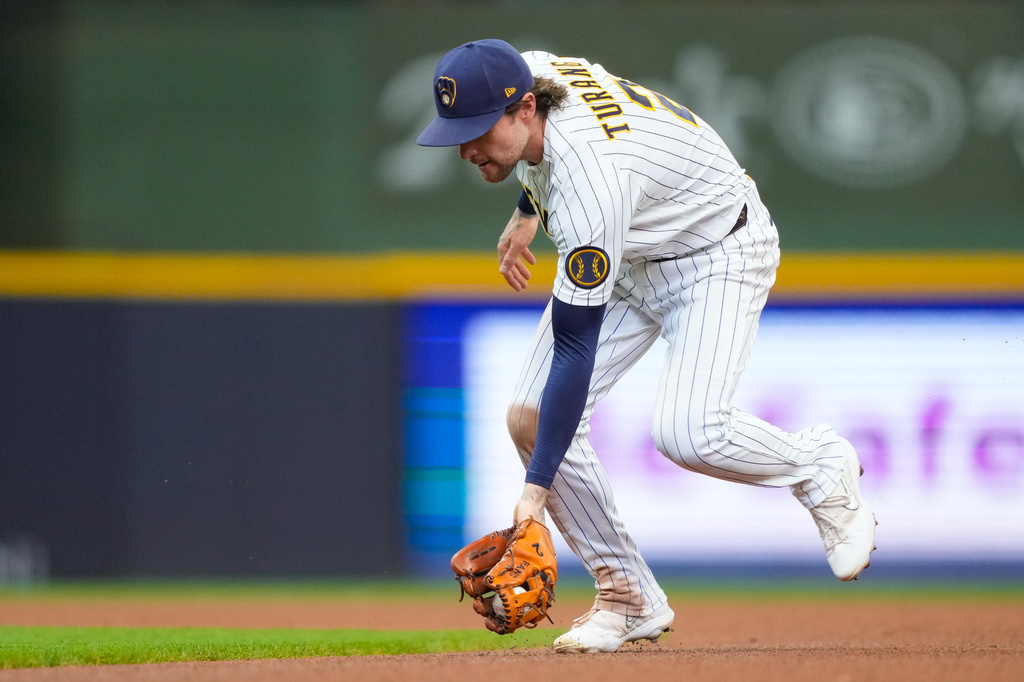 Milwaukee Brewers second baseman Brice Turang fields a groundout hit by Cincinnati Reds' Jose Trevino during the fifth inning of a baseball game Sunday, Sept. 13, 2026, in Milwaukee. (AP Photo/Kayla Wolf)