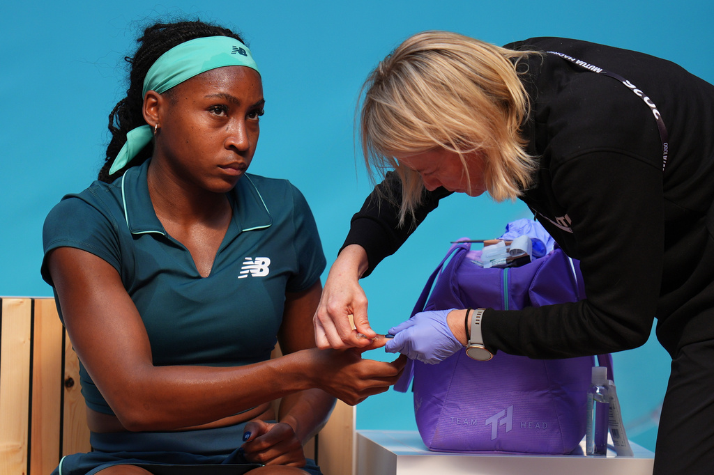 Coco Gauff of the U.S. receives medical attention during her match against Leolia Jeanjean of France during the Madrid Open tennis tournament in Madrid, Friday, April 24, 2026. (AP Photo/Manu Fernandez)