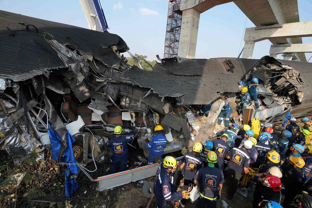 Rescuers work amidst the wreckage after a construction crane fell into a passenger train in Nakhon Ratchasima province, Thailand, Wednesday, Jan.14, 2026. (AP Photo/Sakchai Lalit))