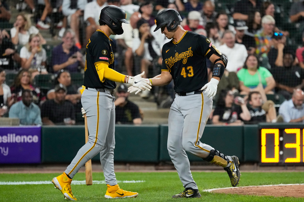 Pittsburgh Pirates' Rafael Flores Jr., right, celebrates with Jacob Gonzalez after hitting a solo home run during the fifth inning of a baseball game against the Chicago White Sox in Chicago, Tuesday, Sept. 8, 2026. (AP Photo/Nam Y. Huh)